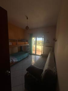 a bedroom with a bunk bed and a couch at Karfas Endless Blue Studio in Karfas