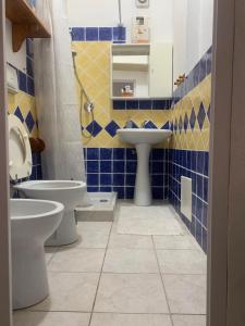 a bathroom with two toilets and a sink at La Stanza del Mare in Calasetta +6 photos