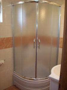 a shower with a glass door in a bathroom at House Mara in Korenica