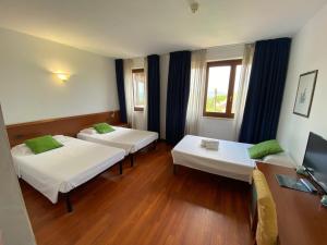 Postel nebo postele na pokoji v ubytování Hotel New Genziana