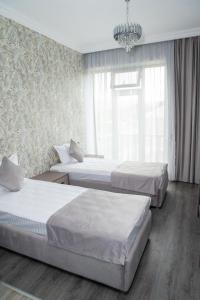 Postel nebo postele na pokoji v ubytování Max Hotel