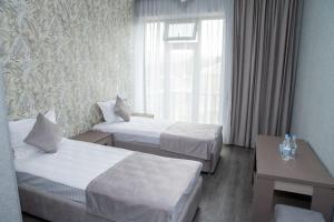 Postel nebo postele na pokoji v ubytování Max Hotel
