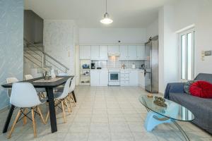 a living room and kitchen with a table and a couch at The Libyan Coast House by Cretanhouses in Paránimfoi