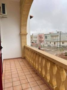 a balcony of a building with a view of a street at Casa vacanza dai Nonni Ntoni in Acquarica del Capo +16 photos
