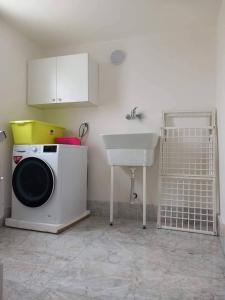 a kitchen with a washing machine and a sink at Casa vacanza dai Nonni Ntoni in Acquarica del Capo +16 photos
