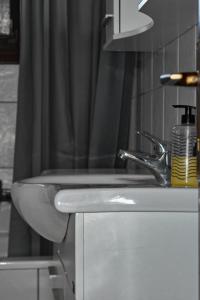 a bathroom with a sink and a shower curtain at Anna's House in Alexandroupoli +20 photos