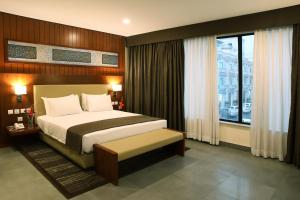 a bedroom with a bed and a large window at Avari Boutique Gujranwala in Fattu Mand +69 photos
