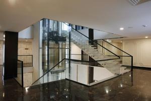 a glass staircase in a house at Avari Boutique Gujranwala in Fattu Mand