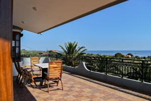 a table and chairs on a balcony overlooking the ocean at Anna's House in Alexandroupoli