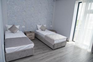 Postel nebo postele na pokoji v ubytování Max Hotel