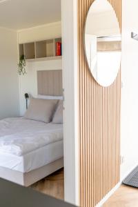 un dormitorio con una cama y un espejo en Black Water Links Village, 