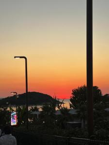 a sunset over a city with a street light at Villa White in Ksamil