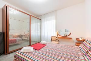 a bedroom with a bed and a mirror at Cappuccini Florence your easy stay close to the center in Florence