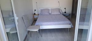 a bedroom with a bed and two chairs in it at Ecolieu La pépinière in Carnoux