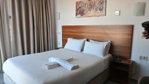 Postel nebo postele na pokoji v ubytování Hotel Centre Ville