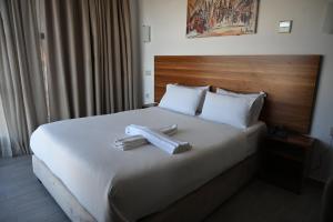 Postel nebo postele na pokoji v ubytování Hotel Centre Ville
