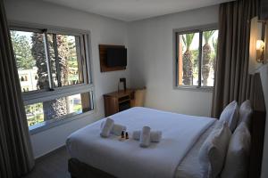 Postel nebo postele na pokoji v ubytování Hotel Centre Ville