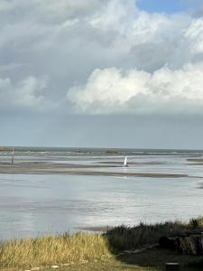 a sail boat in the water on a beach at La Villa d'Elisa in Saint-Côme-de-Fresné
