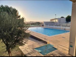 a large swimming pool on top of a building at Casa D' Oliveira in Castro Verde