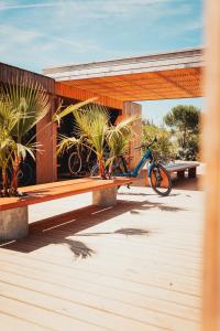 a bike parked under a building with a bench at Le Phare in Les Portes