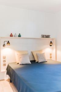 a bedroom with a blue bed with two pillows at Le Phare in Les Portes +37 photos