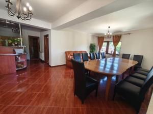 a dining room with a wooden table and chairs at Casa Gabi in Bran