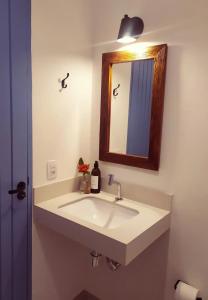 a bathroom with a white sink and a mirror at Villa Tennis in Ubatuba +16 photos