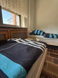two beds sitting in a room with a window at Monteur- und Ferienwohnung Ketsch in Ketsch +9 photos
