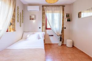 a bedroom with two beds and a window at Elaia's Seaside heaven in Elia Laconias +37 photos