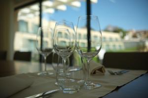 four empty wine glasses sitting on a table at Quinta da Maquia Hotel in Sintra