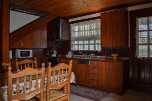 a kitchen with wooden cabinets and a sink at Anna's House in Alexandroupoli