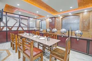 a dining room with a table and chairs at Hotel O THE HOTEL Oshin Hotel & Restaurant in Srinagar