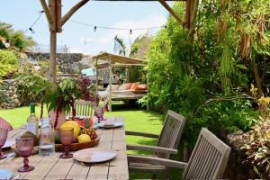 a table with a bowl of fruit on a patio at Golden Wave Villa Lajares in Lajares