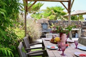 a table with plates and wine glasses on a patio at Golden Wave Villa Lajares in Lajares +40 photos