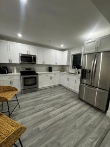 a kitchen with white cabinets and stainless steel appliances at Santuaria Hollywood in Hollywood +60 photos