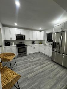 a kitchen with white cabinets and stainless steel appliances at Santuaria Hollywood in Hollywood