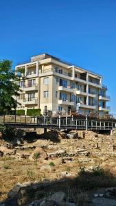 a large building on a bridge over a river at Апартаменты за гости Гавань in Byala