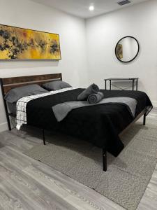 a bedroom with a large bed with a black blanket at Santuaria Hollywood in Hollywood