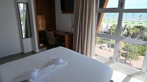 Postel nebo postele na pokoji v ubytování Hotel Centre Ville