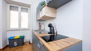 a small kitchen with a sink and a counter at House Dafal by Rentbeat in Guidonia