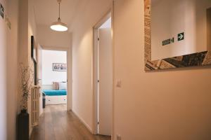 a hallway with a room with a door and a painting on the wall at Milano 71 in Milan
