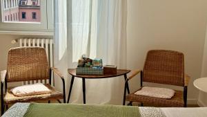a room with two chairs and a table and a window at Milano 71 in Milan