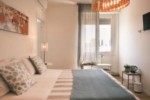 a bedroom with a large bed and a window at Milano 71 in Milan