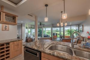 a kitchen with a sink and a counter top at Mauna Lani Point stunning sunset and ocean views in Waikoloa