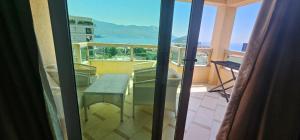 a balcony with a table and a view of the ocean at The Old Town Terrace Apartments in Budva