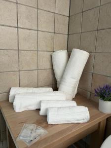 a table with four white towels on it at Elios in in Tropea