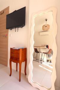 a living room with a mirror and a table at T2 Ajaccio- Neuf tout confort- Wifi et Parking gratuit- 5min du centre ville- Proche aéroport et port- secteur Finosello in Ajaccio