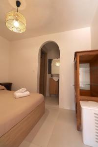 a bedroom with a bed and a bathroom with a mirror at T2 Ajaccio- Neuf tout confort- Wifi et Parking gratuit- 5min du centre ville- Proche aéroport et port- secteur Finosello in Ajaccio