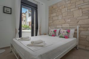 Ένα ή περισσότερα κρεβάτια σε δωμάτιο στο White Pearl Collection