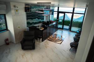 a living room with a table and chairs and windows at miami costinesti in Costinesti